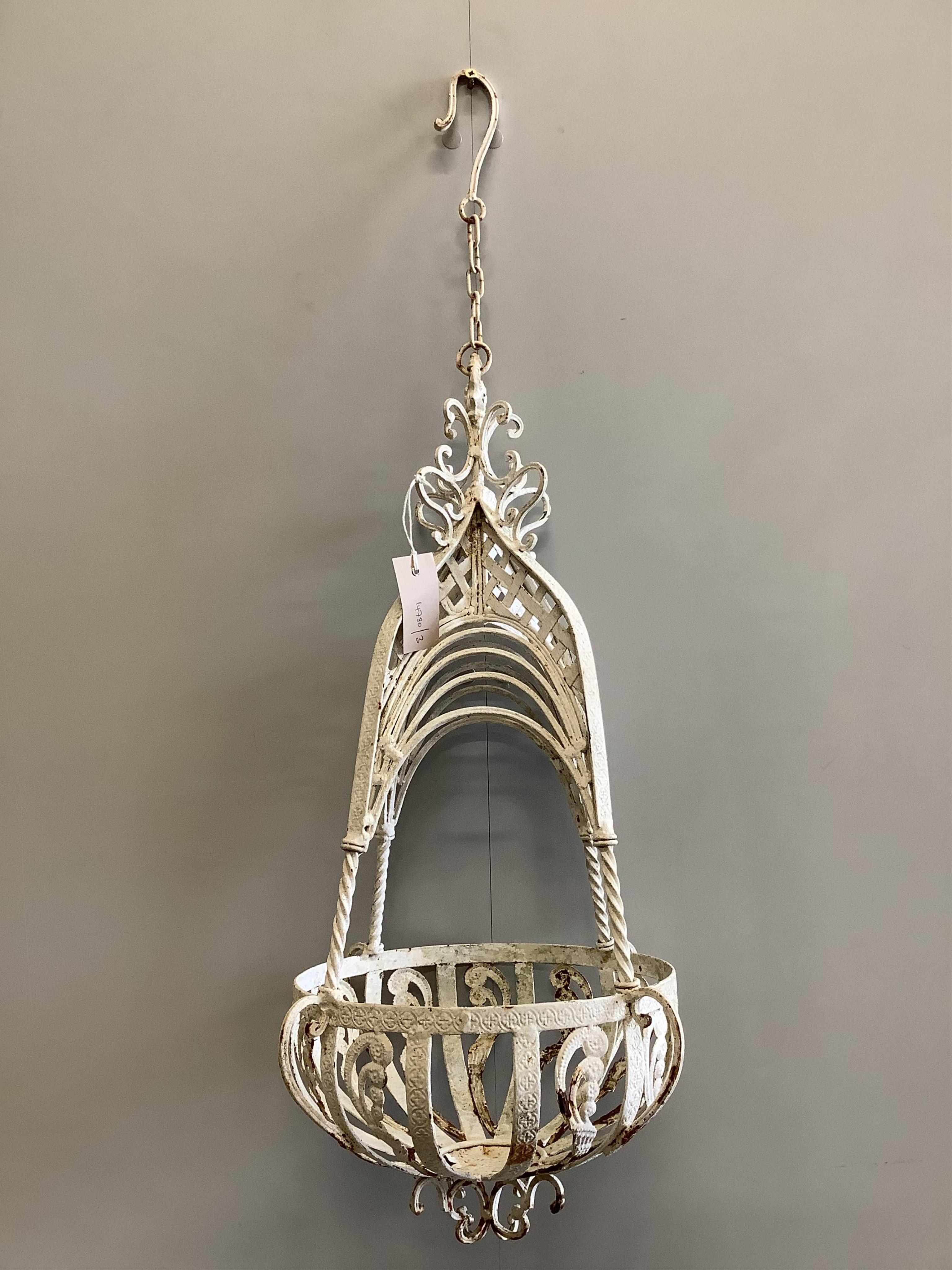 A pair of wrought iron hanging basket planters, height 62cm. Condition - fair
